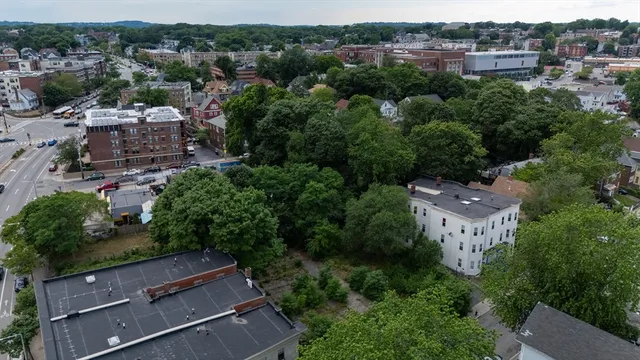 an aerial view of multiple houses with yard
