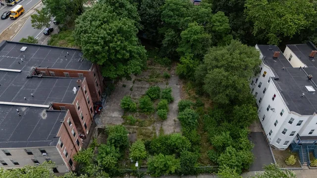 an aerial view of a house with garden space and street view