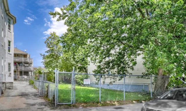 a view of a building front with a garden