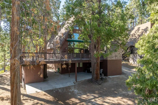 a view of a patio with table and chairs and floor to ceiling window