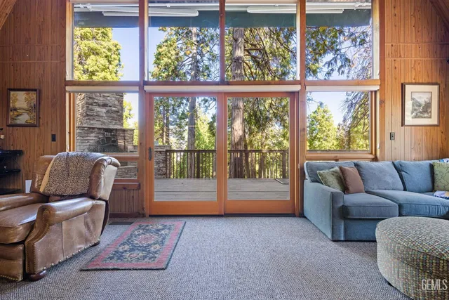 a living room with furniture and a floor to ceiling window