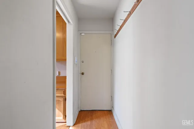 a view of front door with wooden floor