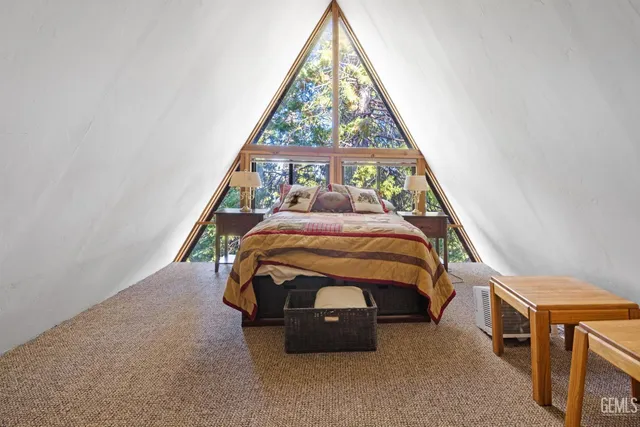 a bedroom with a bed and a tv