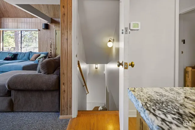 a view of an empty room with wooden floor
