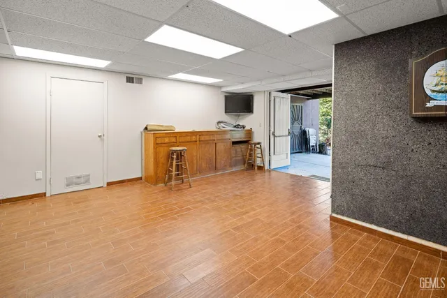 a view of a livingroom with wooden floor and a rug