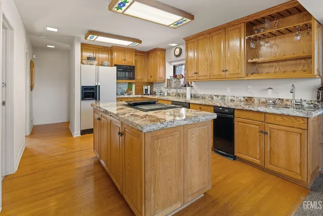 a kitchen with stainless steel appliances granite countertop a sink and cabinets