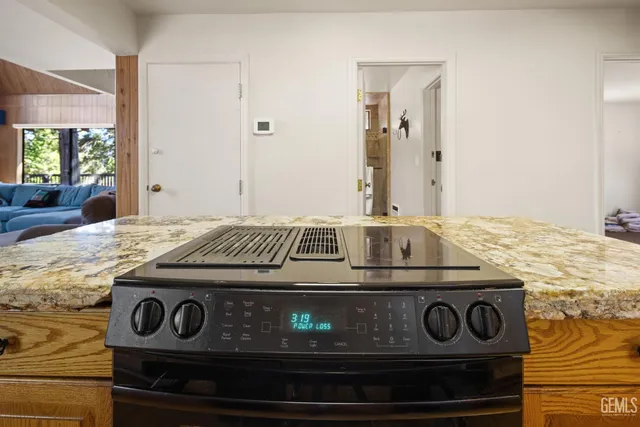 a stove top oven sitting inside of a kitchen