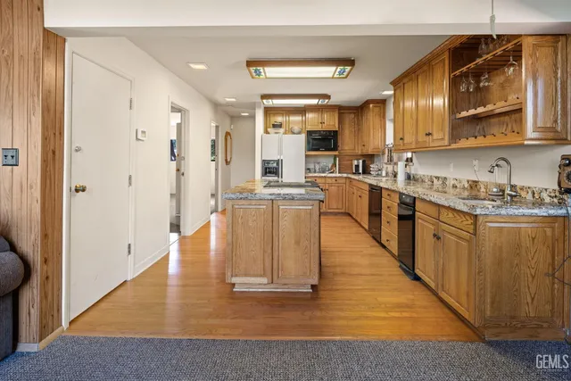 a large white kitchen with lots of counter space and wooden floor