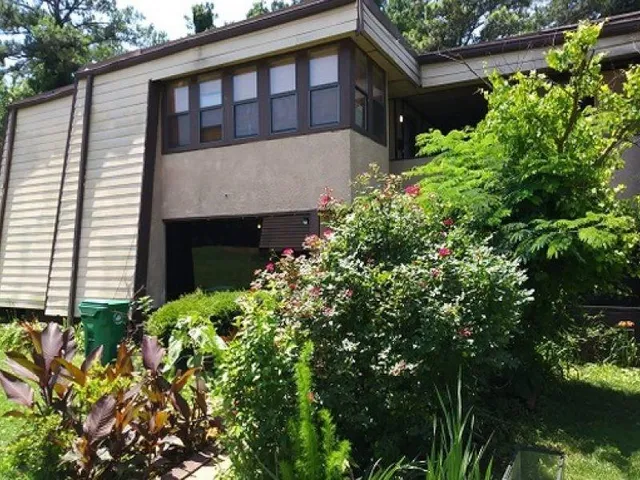 a view of a house with a flower garden