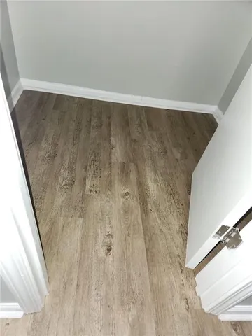 a view of a room with wooden floor