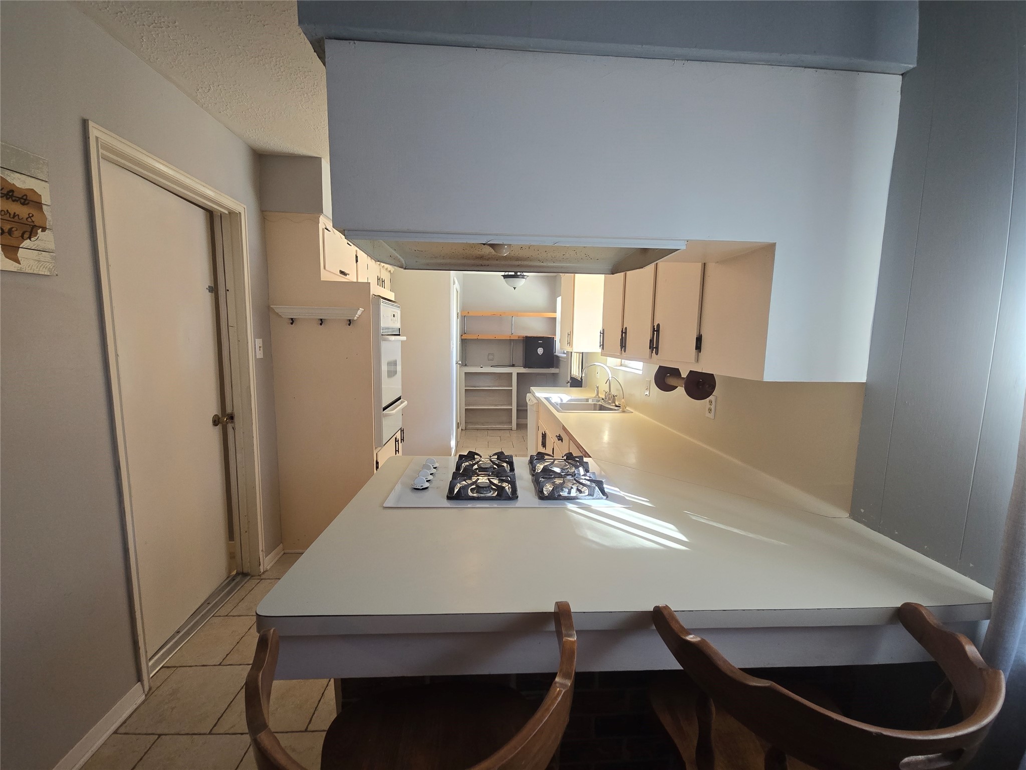 1045 Vine Drive Angleton, TX 77515 - Photo 25 of 48 a room with a table chairs and a refrigerator