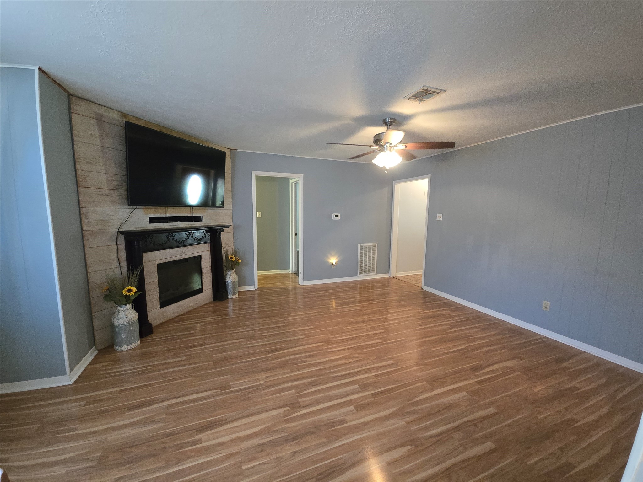 1045 Vine Drive Angleton, TX 77515 - Photo 26 of 48 a view of empty room with wooden floor and fireplace