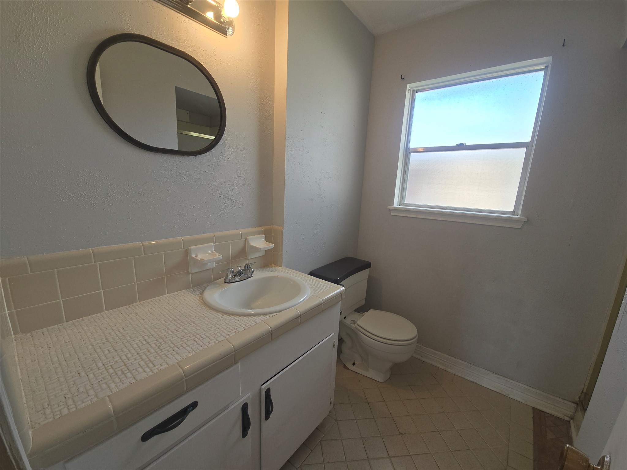 1045 Vine Drive Angleton, TX 77515 - Photo 30 of 48 a bathroom with a toilet sink and mirror
