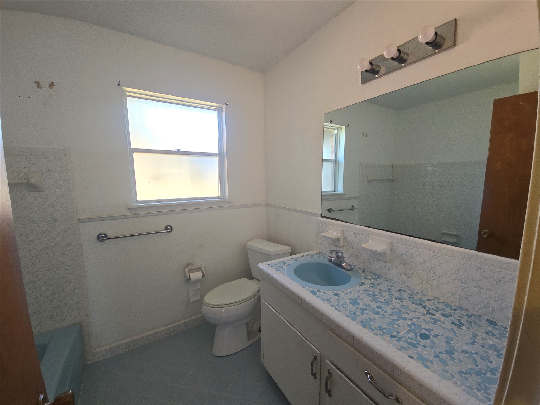 1045 Vine Drive Angleton, TX 77515 - Photo 34 of 42 a bathroom with a granite countertop sink a toilet and mirror