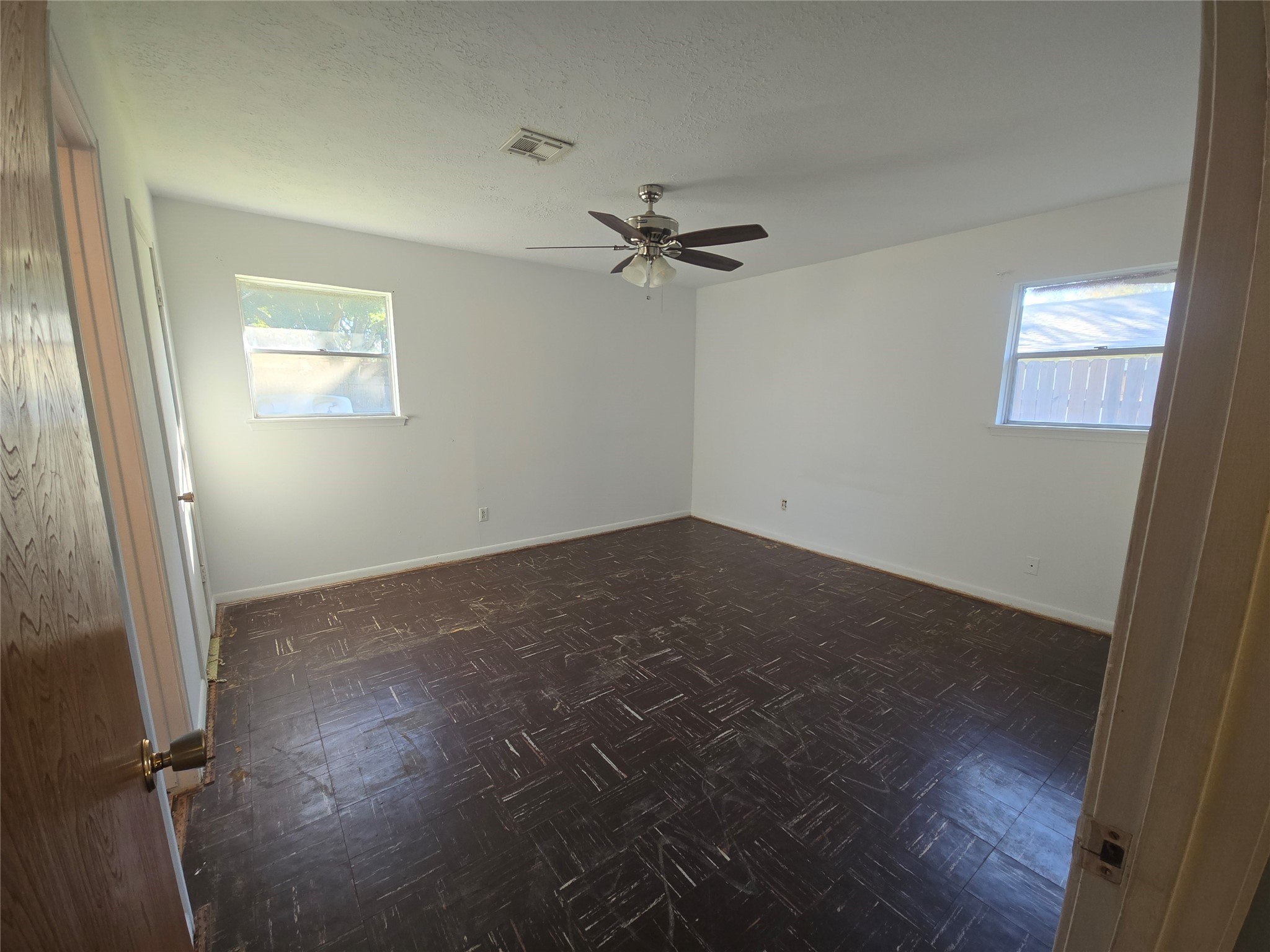 1045 Vine Drive Angleton, TX 77515 - Photo 36 of 42 an empty room with windows and fan