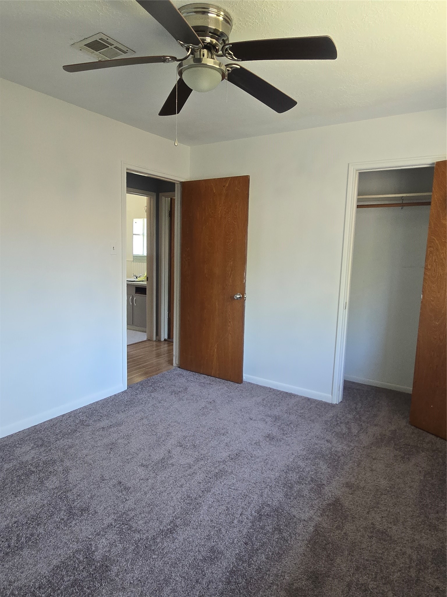 1045 Vine Drive Angleton, TX 77515 - Photo 45 of 48 an empty room with closet and a chandelier fan