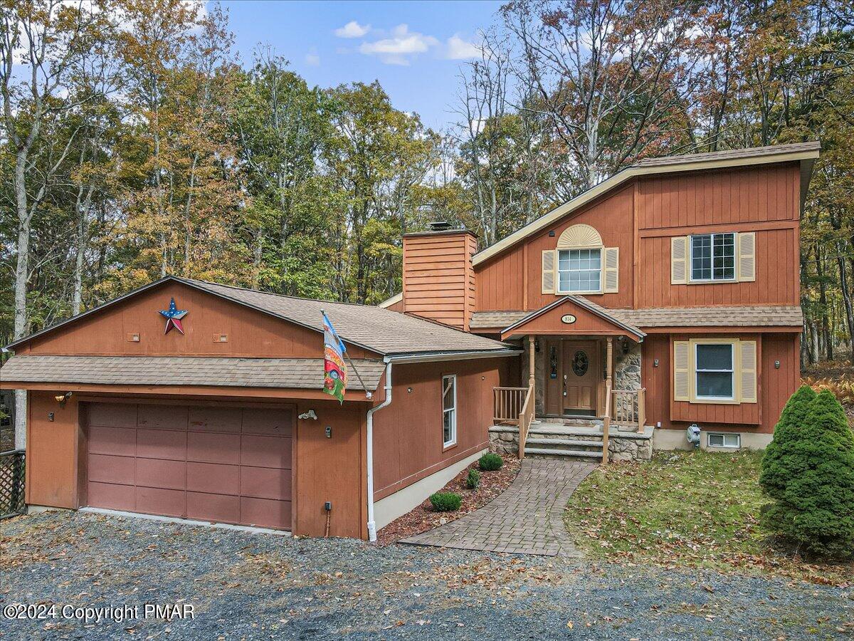 3567 High Crest Road Canadensis, PA 18325 - Photo 2 of 62 a front view of a house with a yard and garage