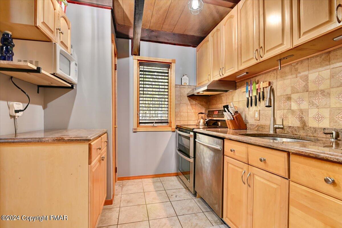 3567 High Crest Road Canadensis, PA 18325 - Photo 19 of 62 a kitchen with granite countertop white cabinets and white appliances