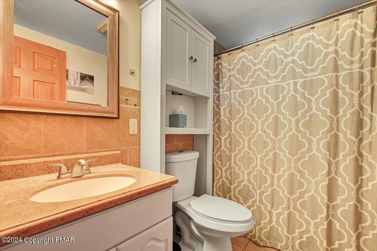 3567 High Crest Road Canadensis, PA 18325 - Photo 30 of 62 a bathroom with a granite countertop sink toilet and shower