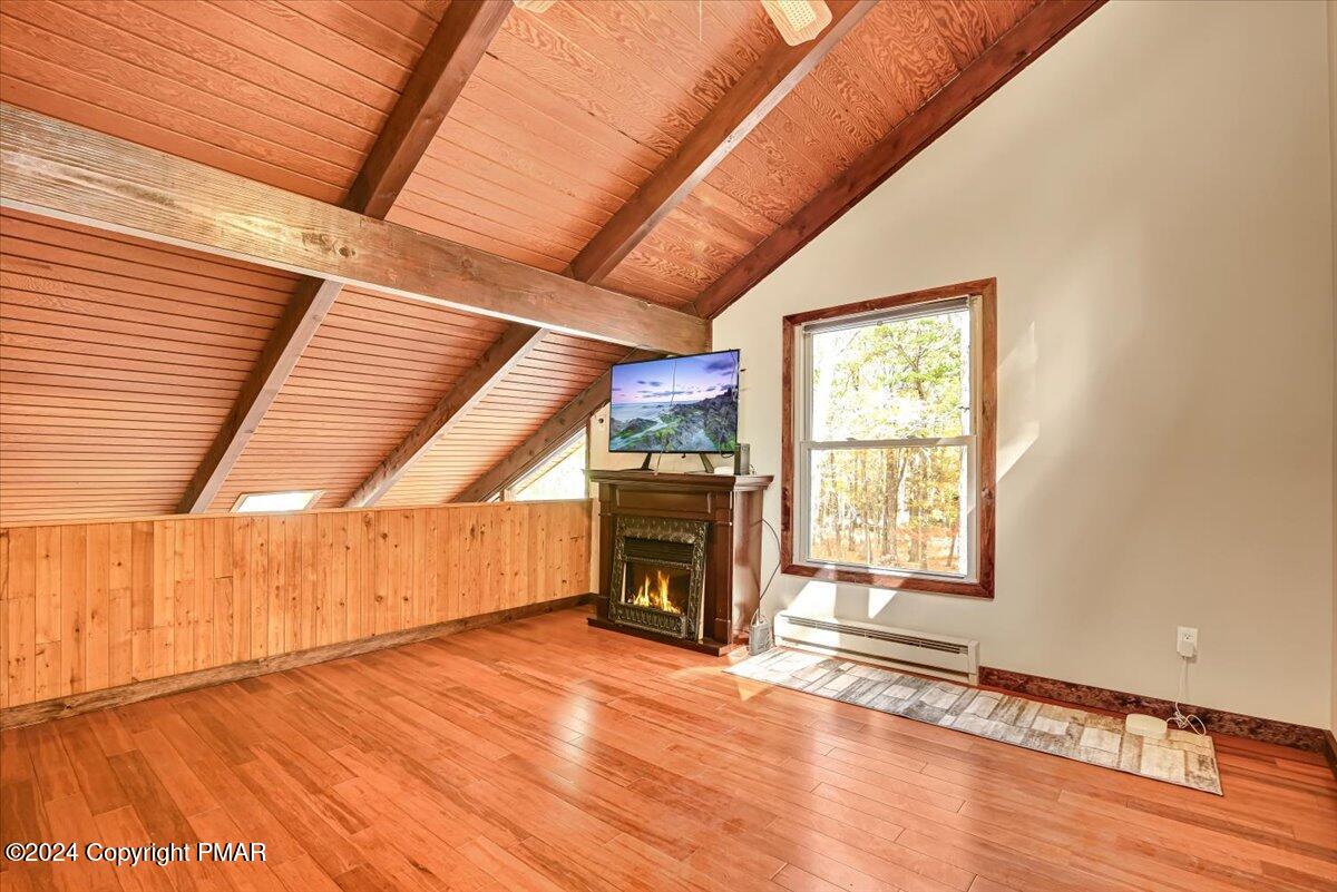 3567 High Crest Road Canadensis, PA 18325 - Photo 31 of 62 an empty room with wooden floor fireplace and windows