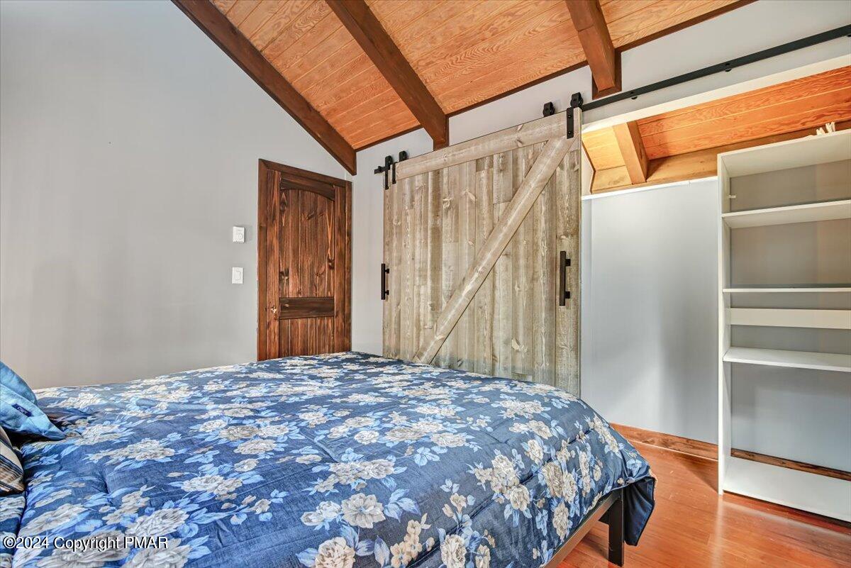 3567 High Crest Road Canadensis, PA 18325 - Photo 37 of 62 a bedroom with a bed and wooden floor