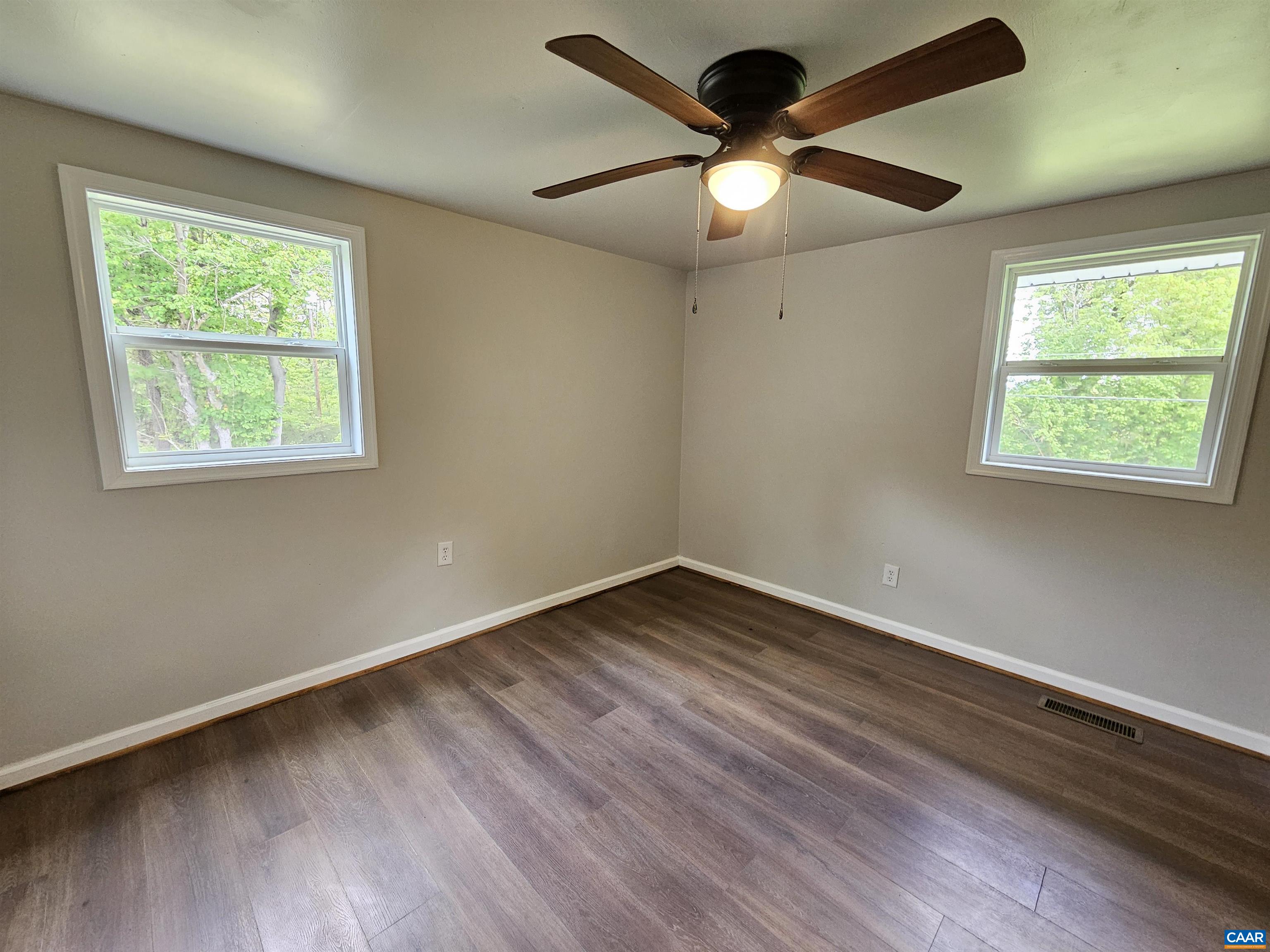 5290 Dixie Hill Road Buckingham, VA 23921 - Photo 13 of 24 a view of an empty room with wooden floor and a window