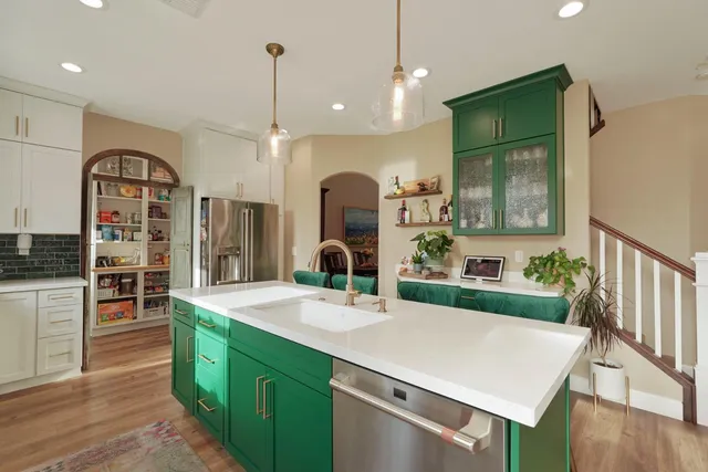 a dining room with furniture a large window and kitchen view