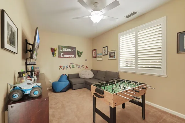 a bedroom with a bed and a painting on the wall