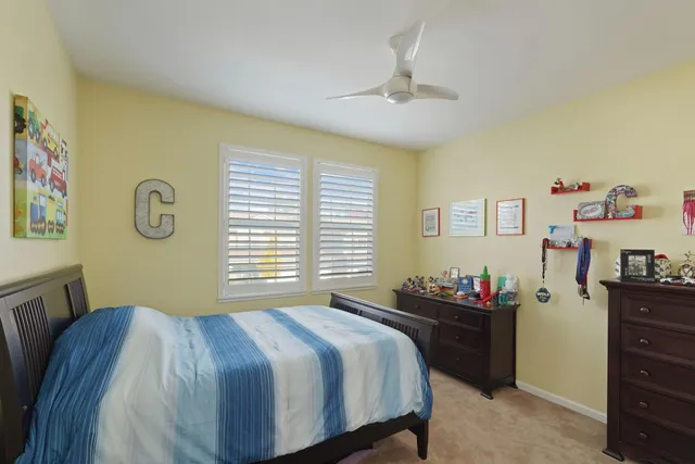 a bedroom with a bed and a dresser