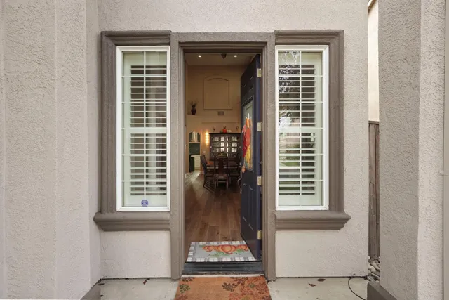 a view of a dining room with furniture wooden floor and a chandelier