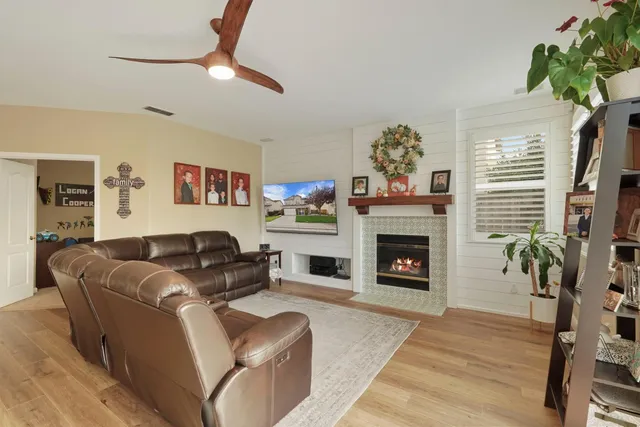 a view of a dining room with furniture a kitchen and chandelier