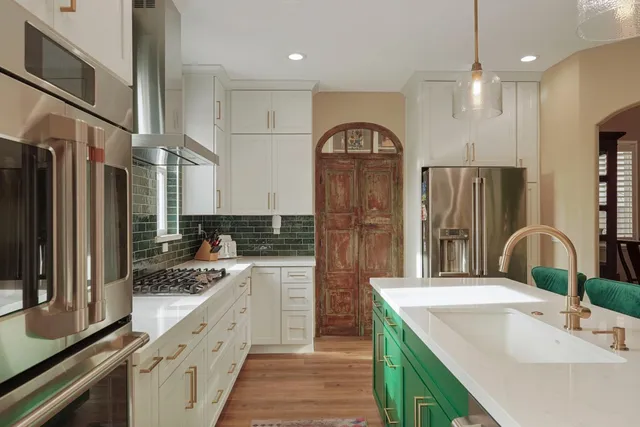 a kitchen with stainless steel appliances granite countertop a sink stove and cabinets
