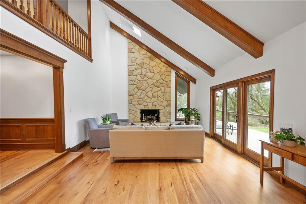 9599 Kummer Road Allison Park, PA 15101 - Photo 3 of 47 Hickory wood flooring runs through most of the first floor. Vaulted and beamed ceilings and a soaring stone fireplace highlight the living room.
