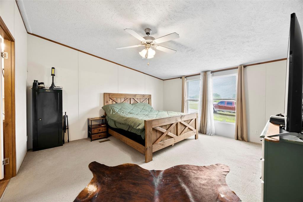 10020 Lavender Road Crowley, TX 76036 - Photo 12 of 29 Bedroom with light colored carpet, ceiling fan, and crown molding
