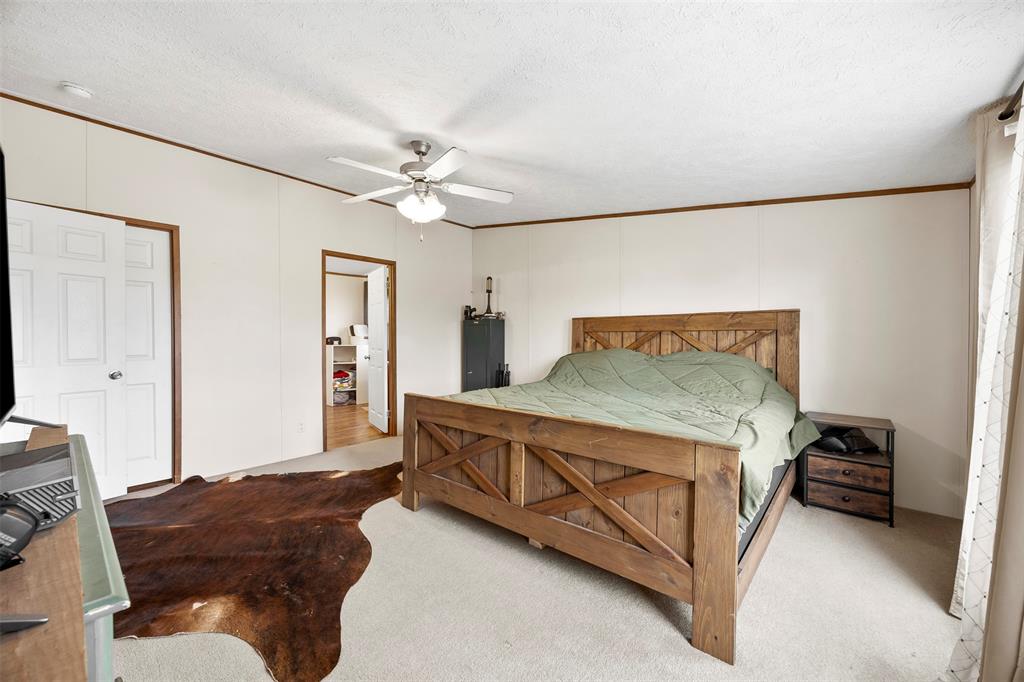 10020 Lavender Road Crowley, TX 76036 - Photo 13 of 29 Bedroom with ceiling fan, ornamental molding, and a textured ceiling