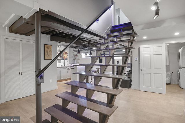 a view of a patio with table and chairs with wooden fence and plants
