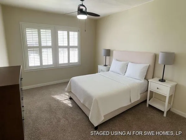 a spacious bedroom with a bed and a window