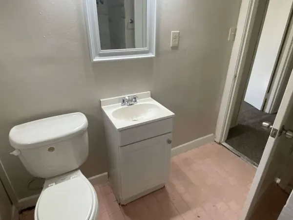 a white toilet sitting next to a bathroom sink