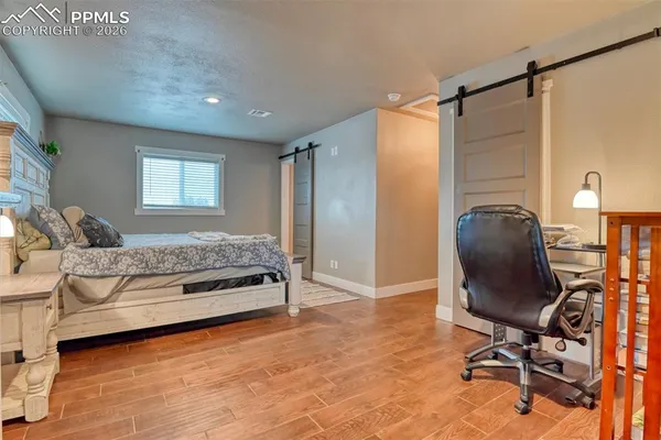 a bedroom with a bed and a chair