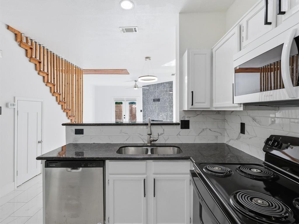 3801 14th Street, Unit 1302 Plano, TX 75074 - Photo 11 of 25 a kitchen with stainless steel appliances granite countertop a sink stove and cabinets