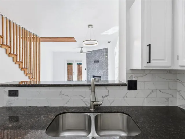 a metallic refrigerator freezer sitting in a kitchen