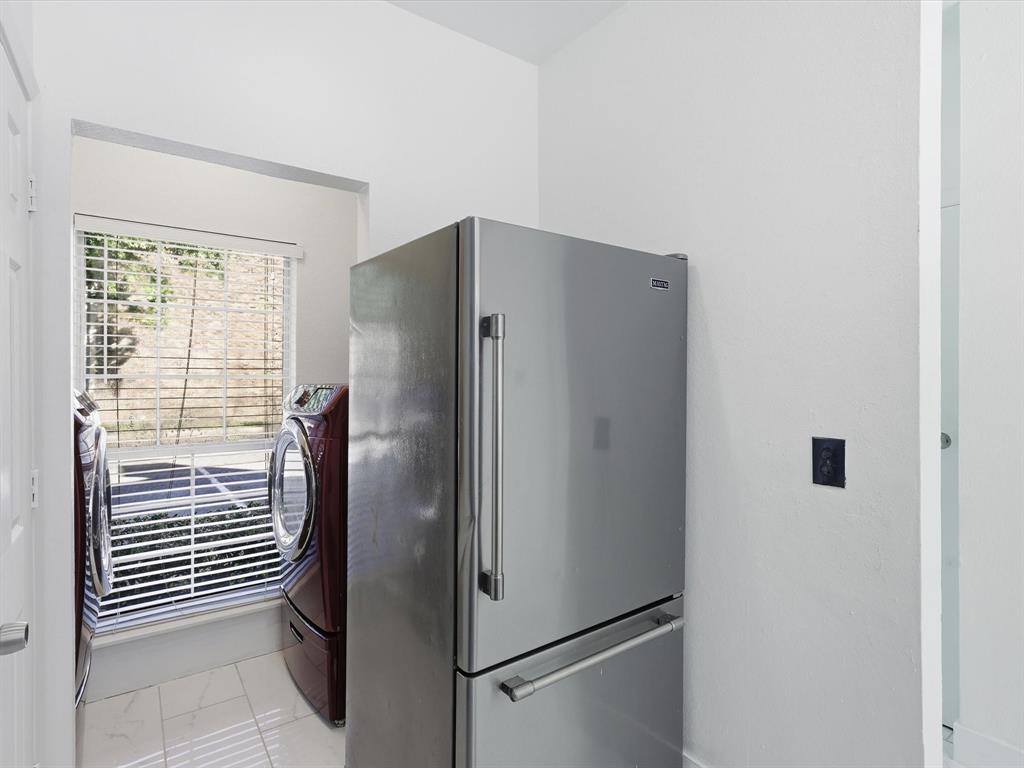 3801 14th Street, Unit 1302 Plano, TX 75074 - Photo 13 of 25 a metallic refrigerator freezer sitting in a kitchen