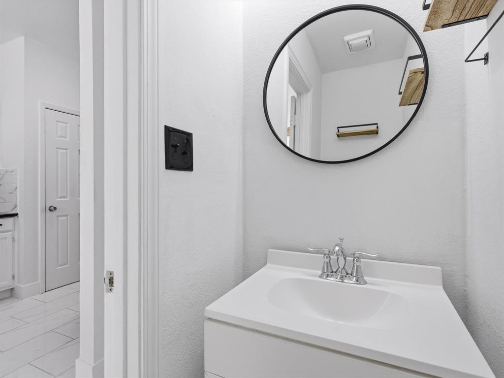 3801 14th Street, Unit 1302 Plano, TX 75074 - Photo 14 of 25 a bathroom with a sink and a mirror