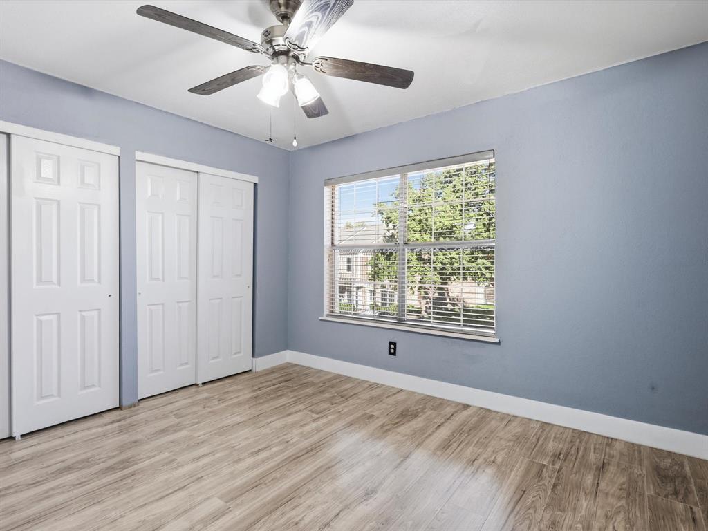 3801 14th Street, Unit 1302 Plano, TX 75074 - Photo 17 of 25 a view of an empty room with a window and wooden floor