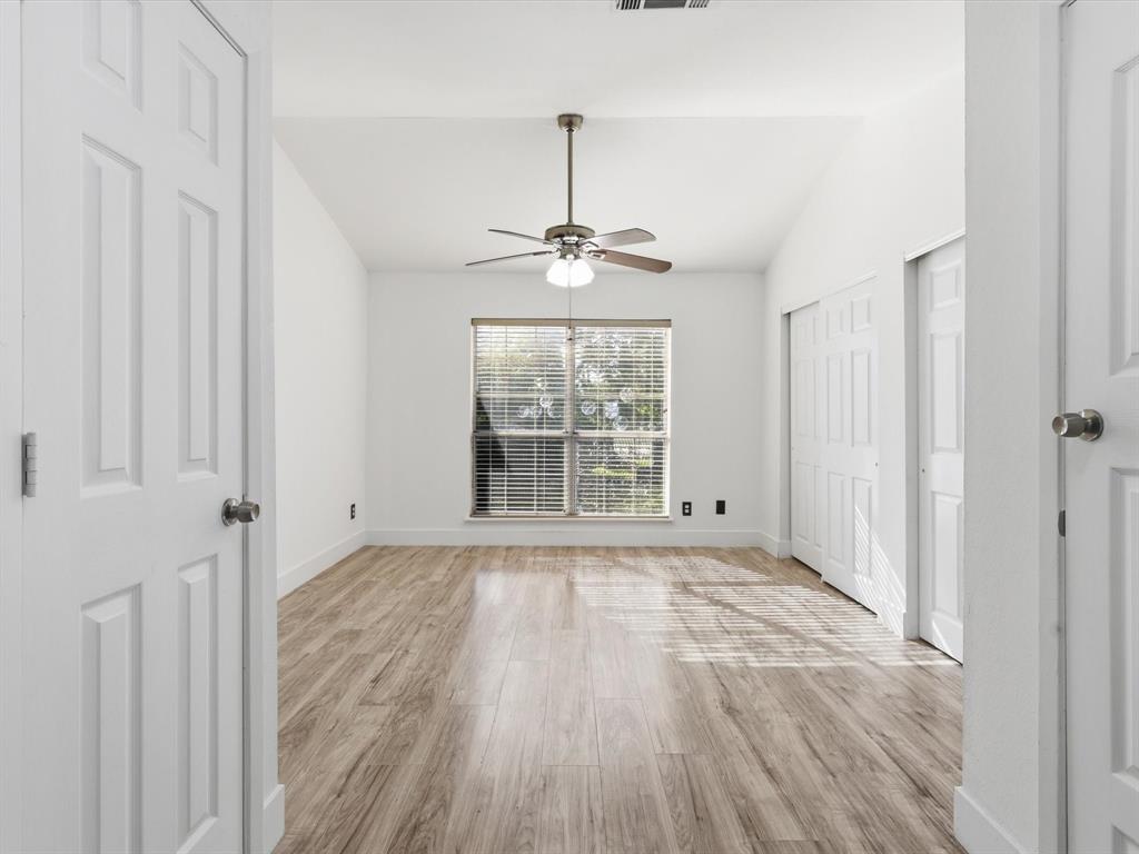 3801 14th Street, Unit 1302 Plano, TX 75074 - Photo 19 of 25 a view of an empty room with wooden floor and a window