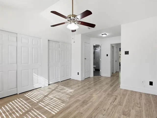 a bathroom with a double vanity sink toilet and shower