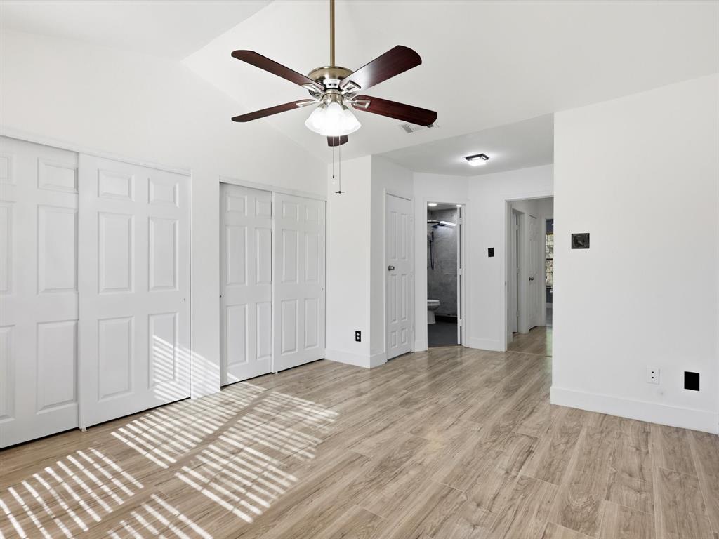 3801 14th Street, Unit 1302 Plano, TX 75074 - Photo 21 of 25 a view of a livingroom with a ceiling fan and wooden floor