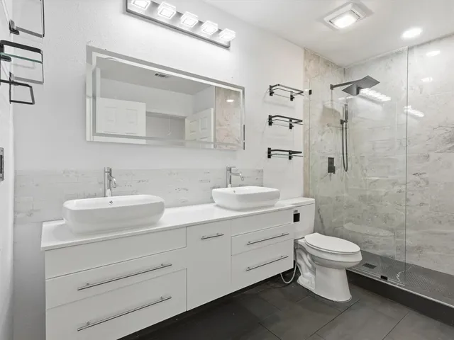 a bathroom with a shower and toilet