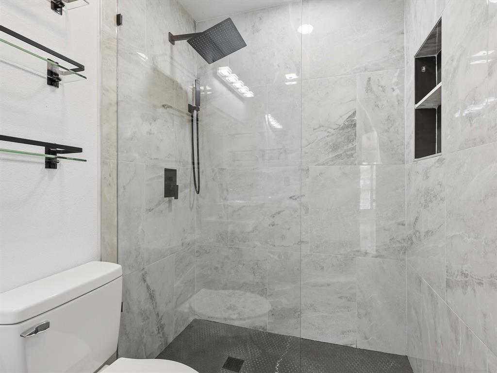 3801 14th Street, Unit 1302 Plano, TX 75074 - Photo 23 of 25 a bathroom with a shower and toilet