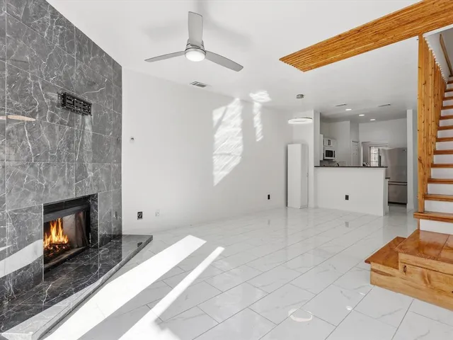 a view of a livingroom with a fireplace and window